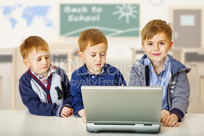 Three children with laptop