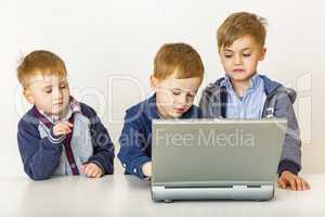 Three children with laptop