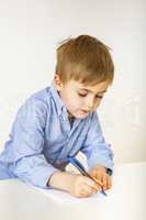 Child with paper and pen