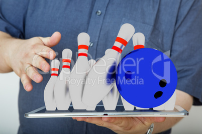 Man with tablet pc and bowling game