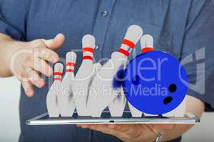 Man with tablet pc and bowling game