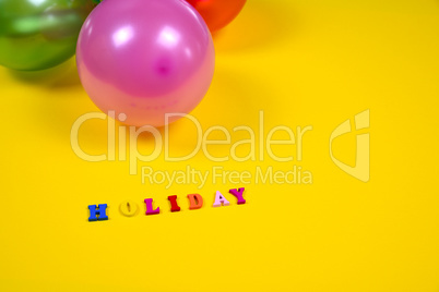 Abstract yellow background with holiday sign and balloons