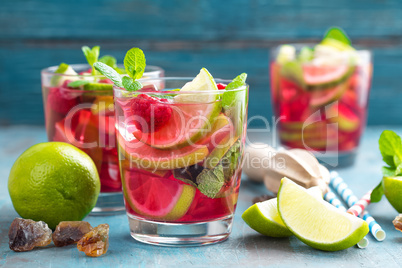 Refreshing mint cocktail mojito with rum, lime and raspberry, cold drink or beverage