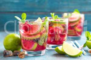 Refreshing mint cocktail mojito with rum, lime and raspberry, cold drink or beverage