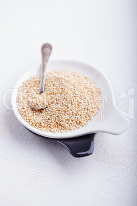 Raw quinoa on wooden table