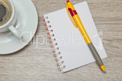 Office space with an empty note book at coffee time looking for inspirational ideas