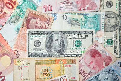 Background from paper money of the different countries. American dollars in the middle