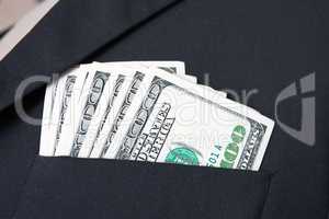United States dollar (USD) bills - in businessman suit pocket
