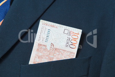 Colombian Pesos in the pocket of a suit
