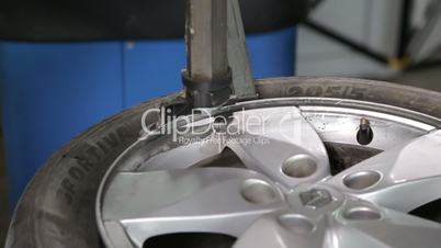 Man Breaking The Tire Off From The Rim by special tool, closeup view