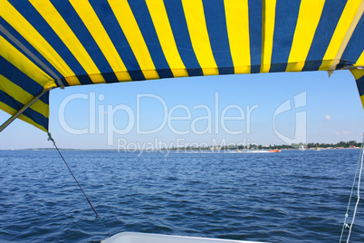 Blue and yellow tent above water surface
