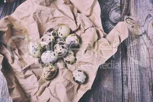Eggs quail on rumpled kraft paper