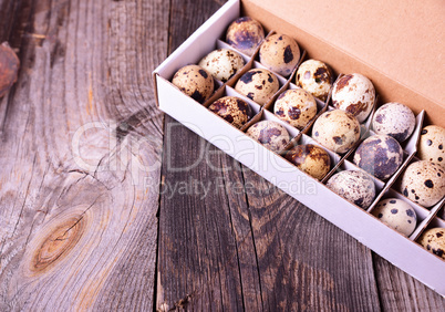 Quail eggs in a paper box with cells