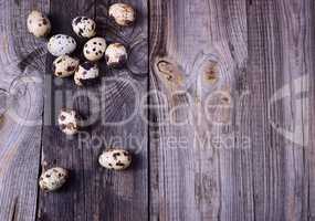 quail eggs on a gray wooden surface