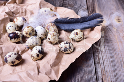 Group of quail raw eggs on brown kraft paper