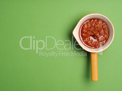Red pesto on green background