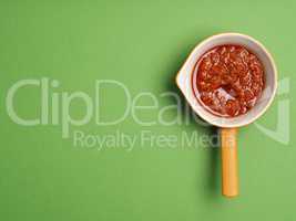 Red pesto on green background