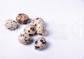 Group of quail eggs on a white surface