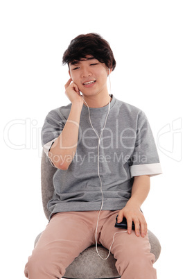 Asian teenager listening to music.