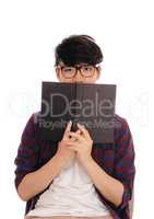 Asian man holding book for face.
