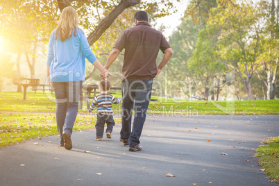 Happy Mixed Race Ethnic Family Walking In The Park