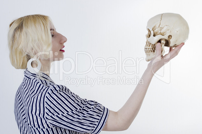 Portrait of a young woman with a skull