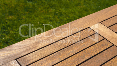 Empty wooden table on grass