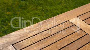 Empty wooden table on grass
