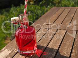 Red juice on a garden table