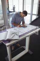 Focused interior designer planning on paper in creative office