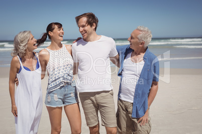 Happy family standing side by side at beach