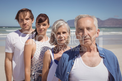 Portrait of serious family standing at beach