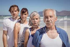 Portrait of serious family standing at beach