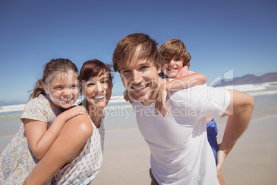 Portrait of family smiling together at beach