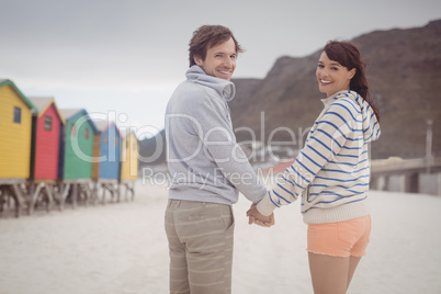 Portrait of couple holding hands at beach