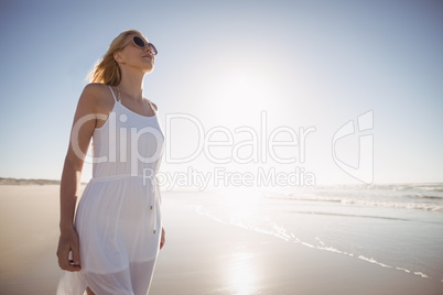 Woman wearing sunglasses on shore at beach