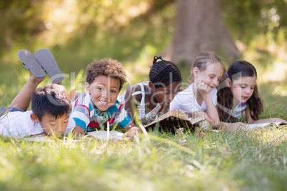 Group of friends reading book at campsite