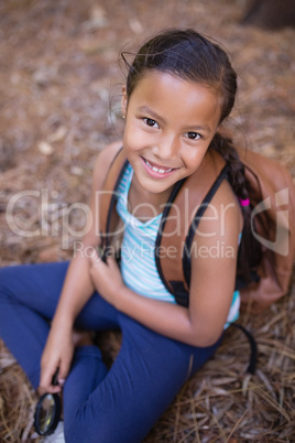 High angle portrait of girl sitting in forest