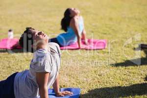Boy and girl practicing yoga on mat