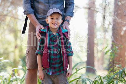 Portrait of happy boy standing with father