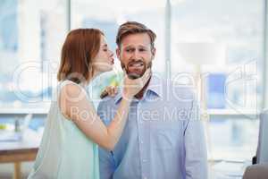 Affectionate woman kissing man