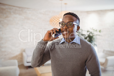 Smiling executive talking on mobile phone