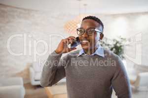 Smiling executive talking on mobile phone