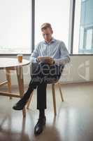 Attentive executive using digital tablet at table
