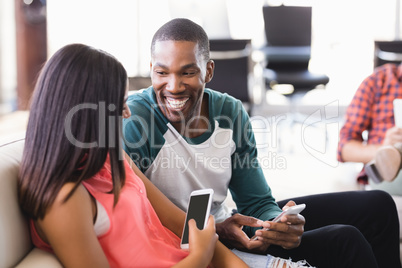 Happy business colleagues sitting in office