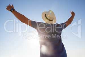 Man standing at beach with arms outstretched