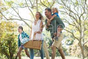 Family arriving in the park for picnic on a sunny day