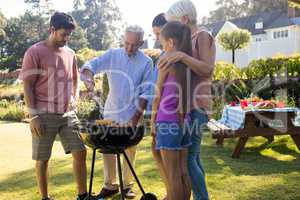 Family preparing barbecue in the park