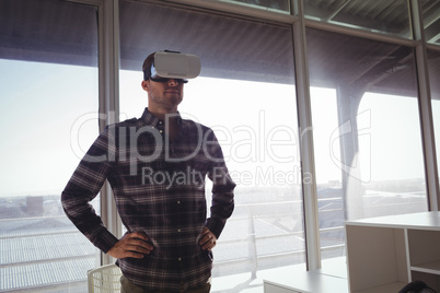 Businessman wearing virtual reality headset in office