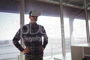 Businessman wearing virtual reality headset in office